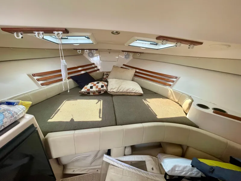 Slide: The Image of 2009 Grady-White 330 Explorer cabin interior with cozy bedding and skylights. - 4
