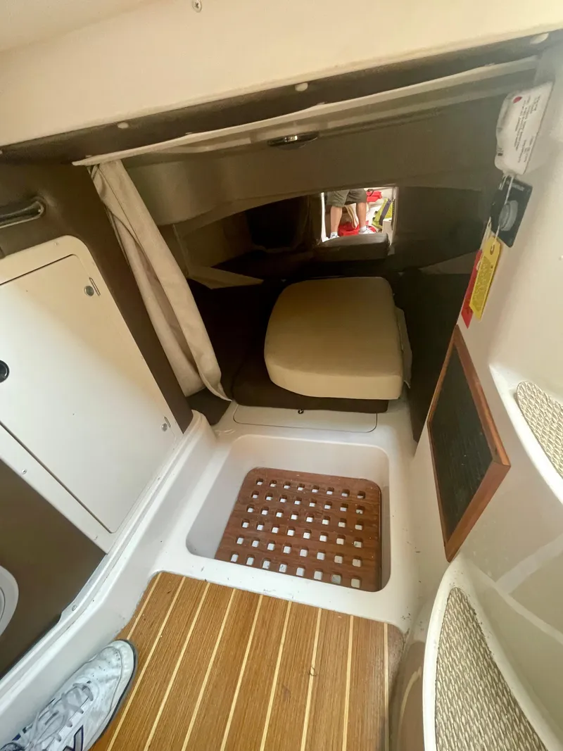 Slide: The Image of 2009 Grady-White 330 Explorer cabin interior with wooden flooring and seating area. - 7