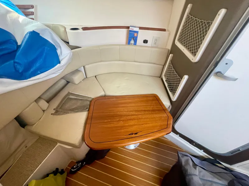Slide: The Image of 2009 Grady-White 330 Explorer cabin interior with wooden table and seating area. - 8