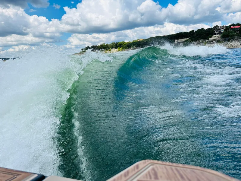 Slide: The Image of Centurion Ri245 2021 creating a large wake on a sunny day with clouds. - 11