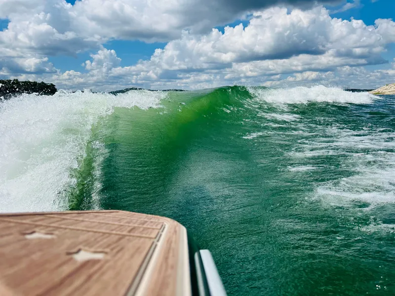 Slide: The Image of Centurion Ri245 2021 creating a vibrant wake on a sunny day. - 14