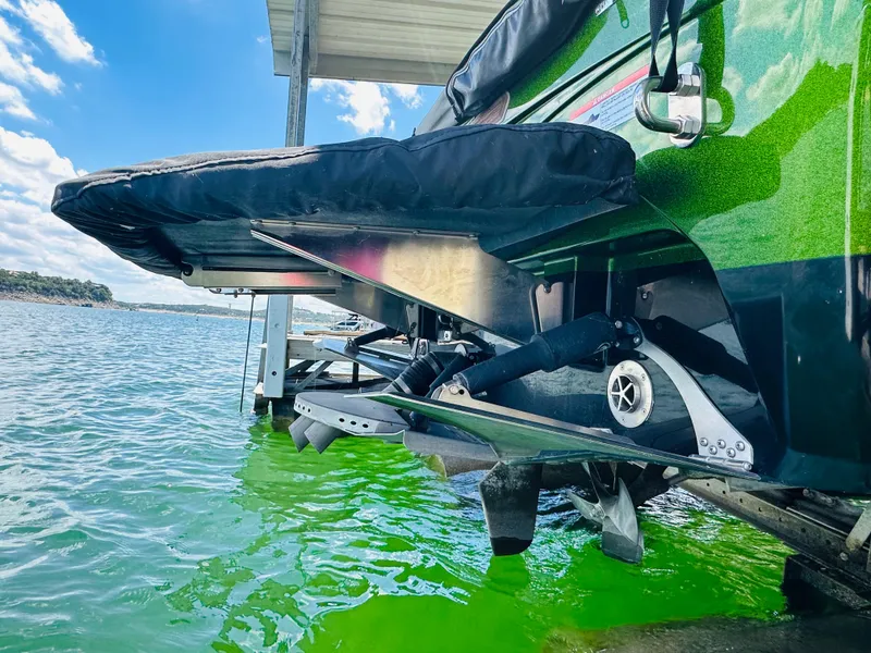 Slide: The Image of 2021 Centurion Ri245 boat on water, showcasing sleek green hull design. - 22