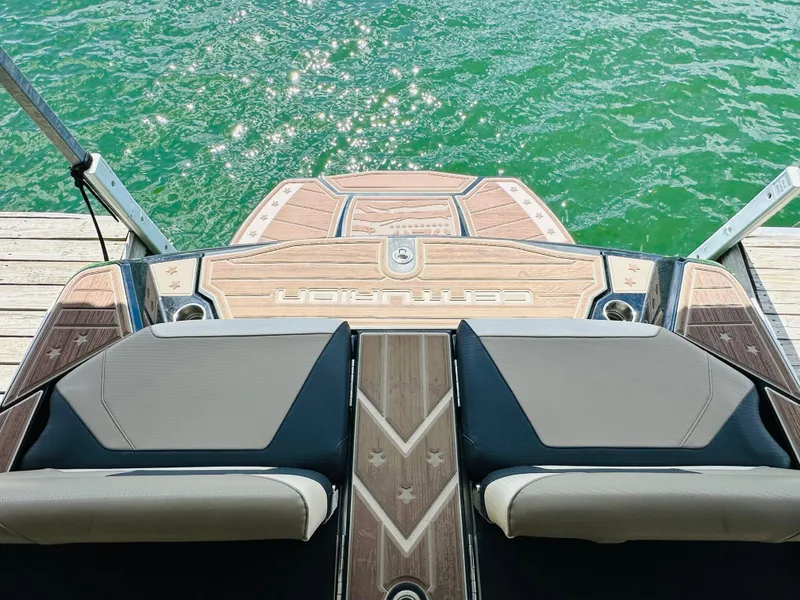 Slide: The Image of 2021 Centurion Ri245 boat at dock, featuring sleek design and luxurious seating. - 24