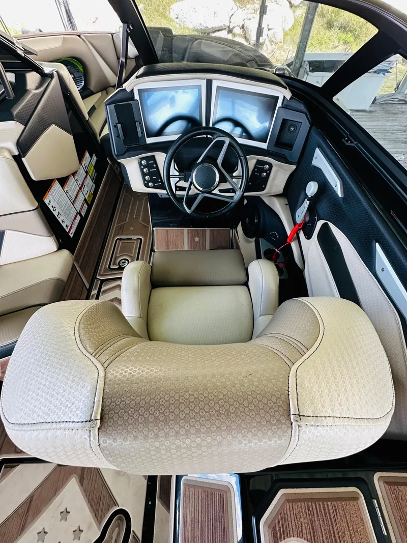 Slide: The Image of 2021 Centurion Ri245 boat cockpit with modern dashboard and steering wheel. - 32