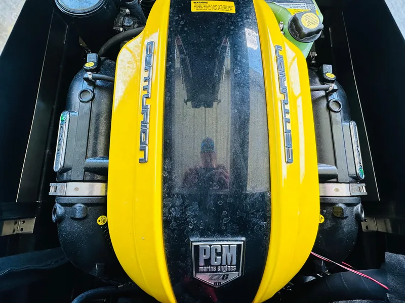 Slide: The Image of 2021 Centurion Ri245 engine with yellow cover and PCM branding. - 40