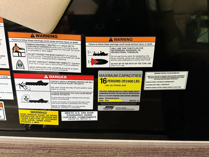 Slide: The Image of Warning and capacity labels on a 2021 Centurion Ri245 boat. - 44