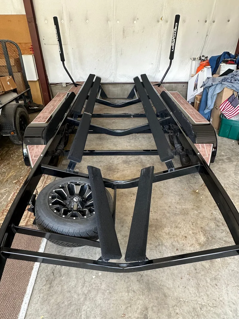 Slide: The Image of Centurion Ri245 2021 boat trailer with spare tire in a garage setting. - 48