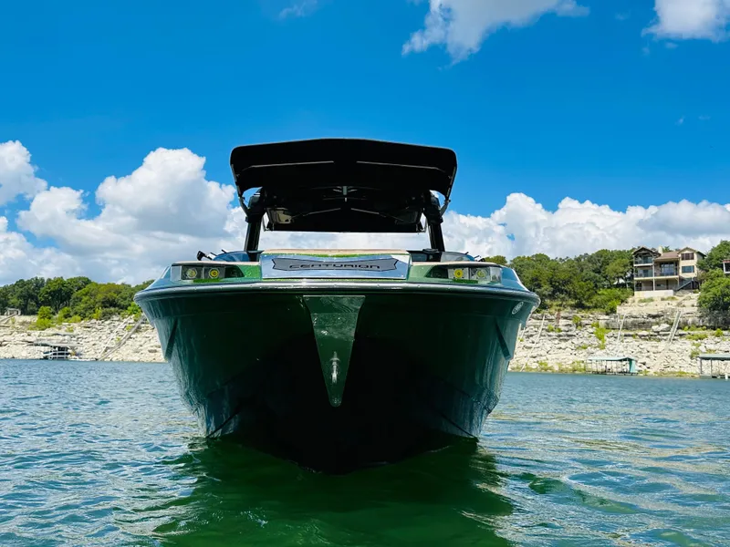 Slide: The Image of 2021 Centurion Ri245 boat on a lake with scenic background. - 5