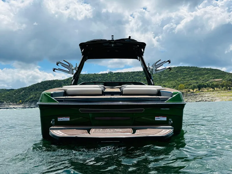 Slide: The Image of 2021 Centurion Ri245 boat on water with scenic background. - 9