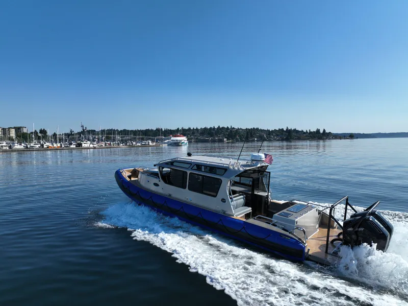 Slide: The Image of 2023 Life Proof 35 Full Cabin boat cruising on a calm lake near a marina. - 4
