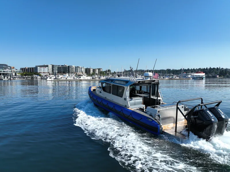 Slide: The Image of 2023 Life Proof 35 Full Cabin boat cruising in a marina under clear blue skies. - 5