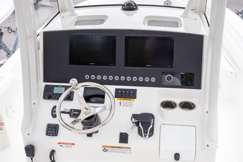 Slide: The Image of Helm of 2025 Regulator 26XO boat with dual screens and modern controls. - 10