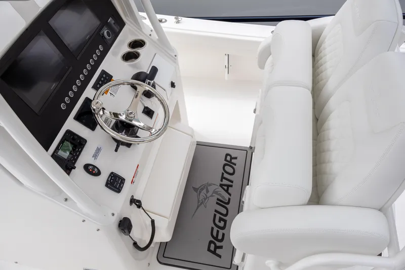 Slide: The Image of 2025 Regulator 26XO boat cockpit with steering wheel and dual seating. - 12