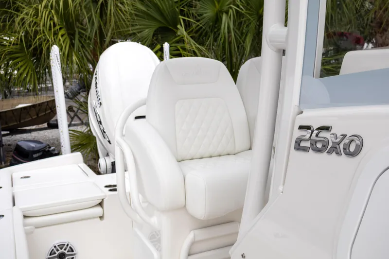 Slide: The Image of 2025 Regulator 26XO boat interior with white seating and engine, surrounded by greenery. - 17