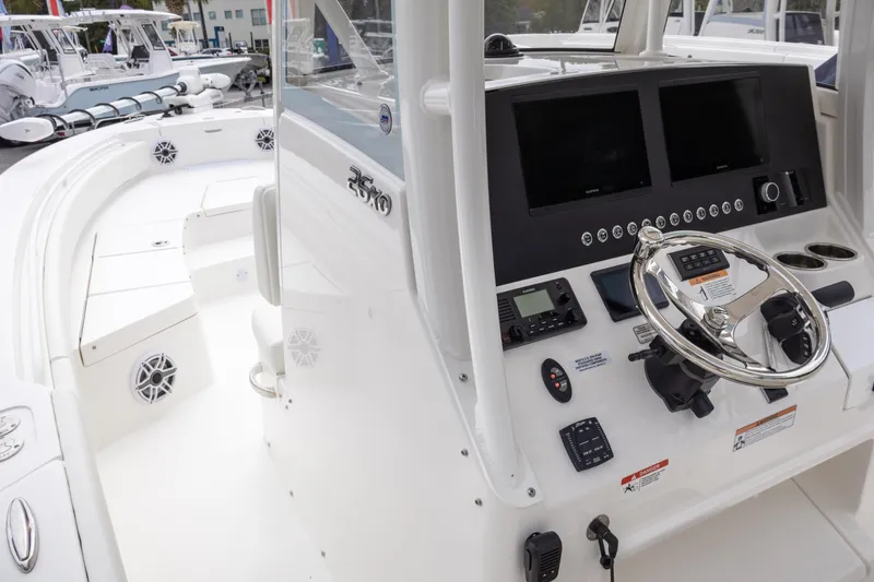 Slide: The Image of 2025 Regulator 26XO boat cockpit with modern controls and dual screens. - 21
