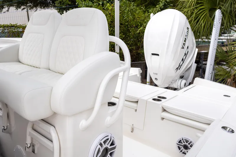 Slide: The Image of 2025 Regulator 26XO boat interior with white seating and Yamaha outboard motor. - 22