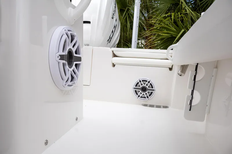 Slide: The Image of 2025 Regulator 26XO boat interior with speakers and sleek white design. - 23