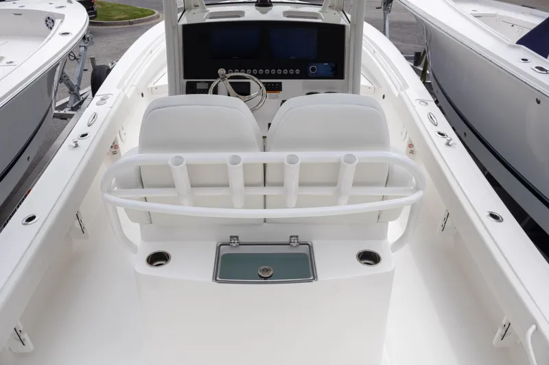 Slide: The Image of 2025 Regulator 26XO boat interior with dual seats and fishing rod holders. - 25