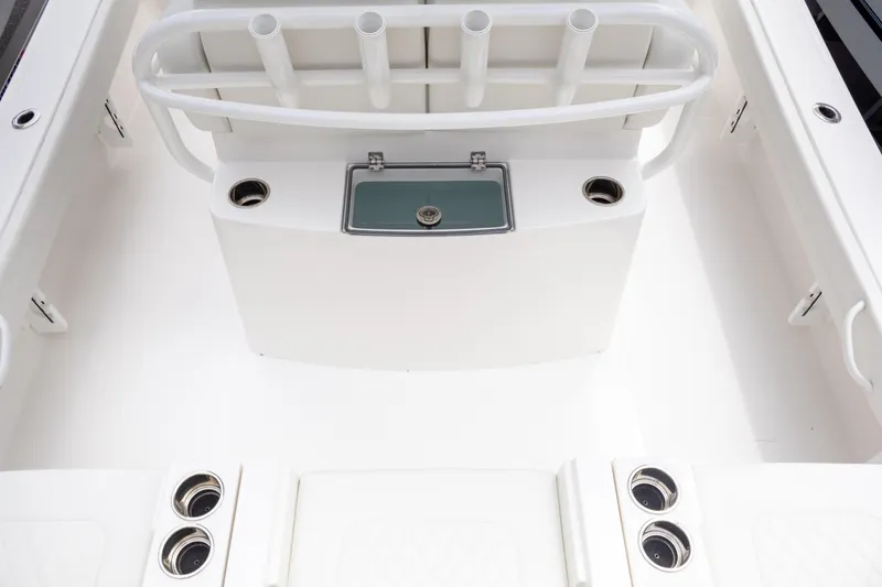 Slide: The Image of 2025 Regulator 26XO boat interior with rod holders and storage compartments. - 26
