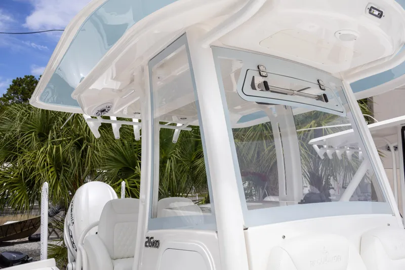 Slide: The Image of 2025 Regulator 26XO boat with sleek design and modern features, set against a tropical backdrop. - 29