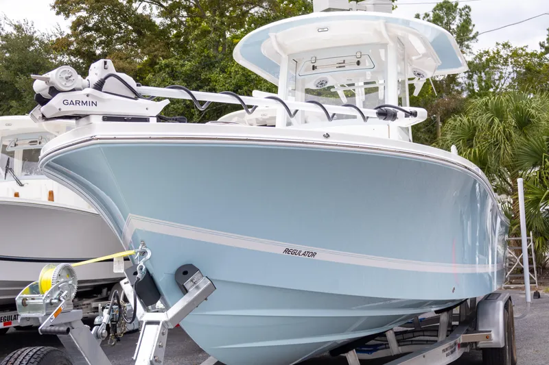 Slide: The Image of 2025 Regulator 26XO boat on trailer, featuring Garmin equipment, light blue hull. - 3