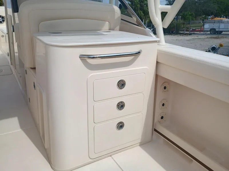 Slide: The Image of 2025 Grady-White Freedom 275 boat interior with storage drawers and sleek design. - 11