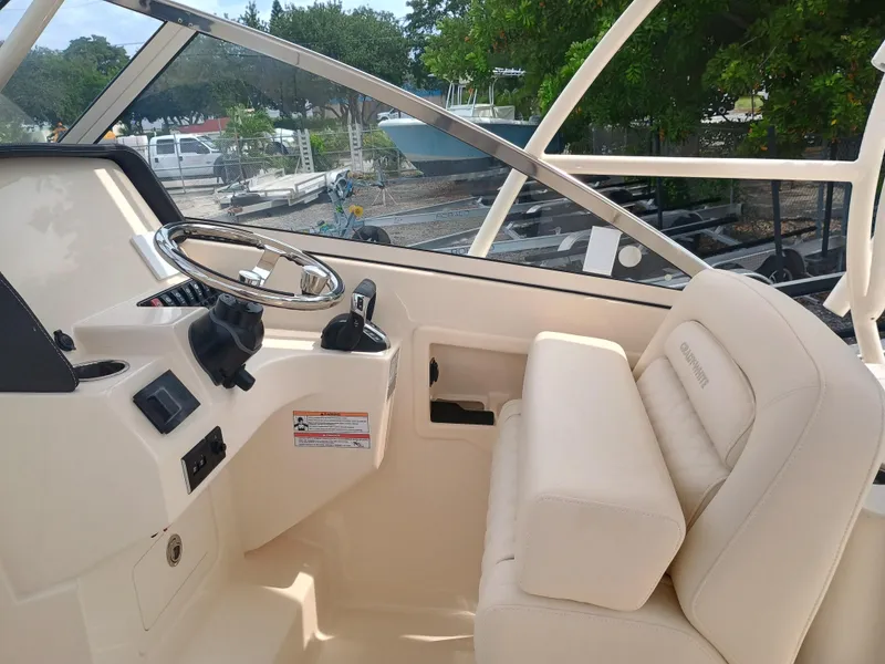 Slide: The Image of 2025 Grady-White Freedom 275 boat interior with steering wheel and seating. - 15