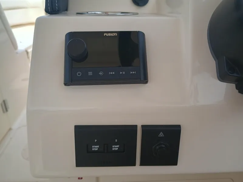 Slide: The Image of Control panel of 2025 Grady-White Freedom 275 boat with Fusion audio system. - 19