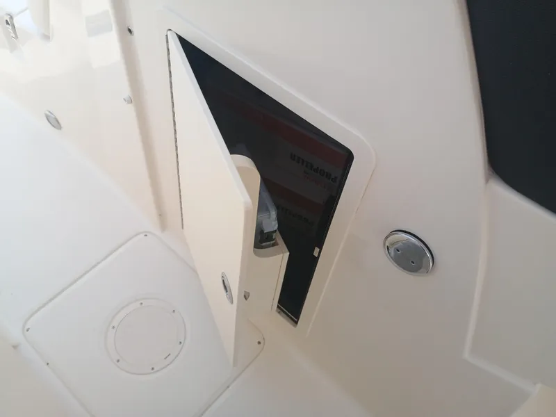 Slide: The Image of 2025 Grady-White Freedom 275 boat storage compartment with open hatch. - 22