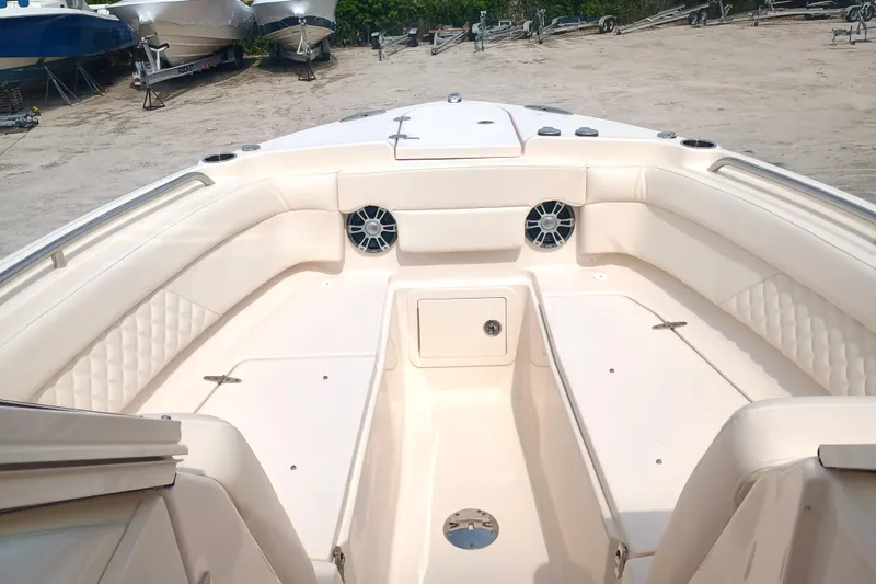 Slide: The Image of 2025 Grady-White Freedom 275 boat interior with spacious seating and speakers. - 5