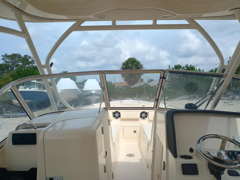 Slide: The Image of 2025 Grady-White Freedom 275 boat interior with steering wheel and dashboard. - 6