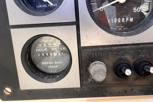 Slide: The Image of Hour meter and controls on 1992 Pacific Seacraft 37 Cutter boat dashboard. - 23