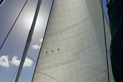 Slide: The Image of Sailing on a 1992 Pacific Seacraft 37 Cutter with sunlit sails and clear skies. - 31