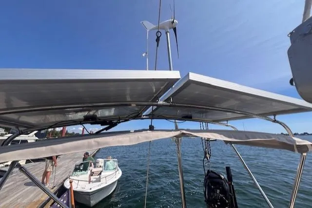 Slide: The Image of 1992 Pacific Seacraft 37 Cutter with solar panels and wind turbine on deck. - 39