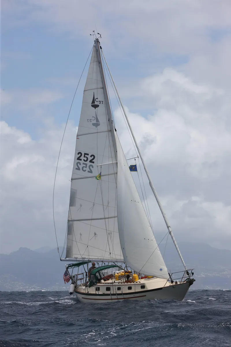Slide: The Image of 1992 Pacific Seacraft 37 Cutter sailing on open sea under cloudy skies. - 41