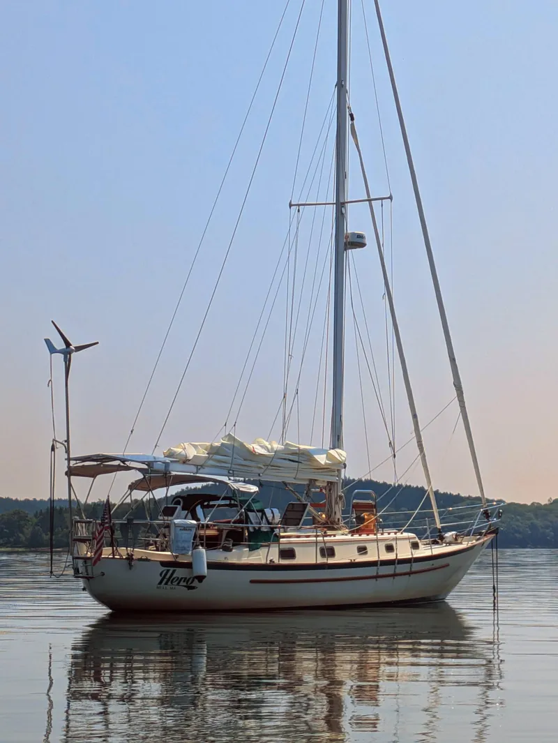 Slide: The Image of 1992 Pacific Seacraft 37 Cutter sailboat anchored on calm water. - 44