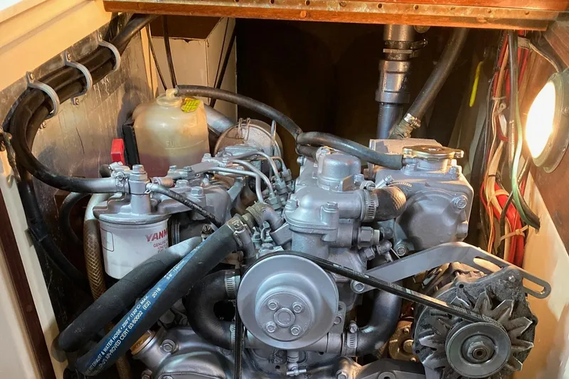Slide: The Image of Engine compartment of a 1992 Pacific Seacraft 37 Cutter sailboat, featuring Yanmar components. - 28