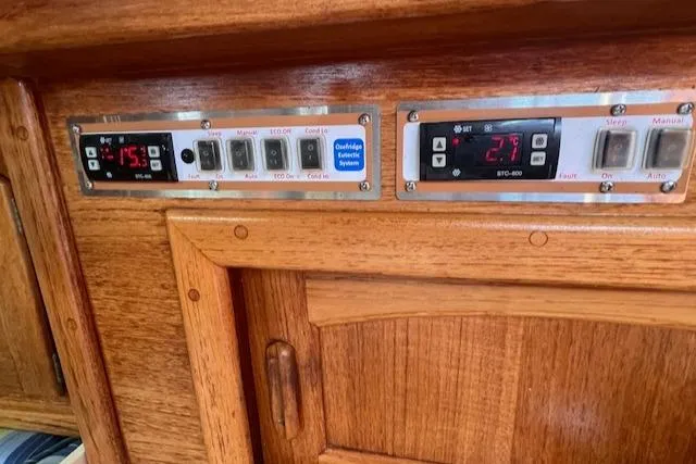 Slide: The Image of Control panel on 1992 Pacific Seacraft 37 Cutter, featuring wooden cabinetry and electronic displays. - 30