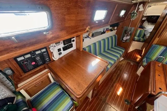 Slide: The Image of Interior of 1992 Pacific Seacraft 37 Cutter with wood finish and striped seating. - 7