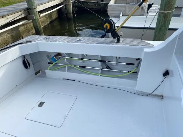 Slide: The Image of 1985 Bertram 38 Convertible fishing deck with rod holder and storage compartments. - 14
