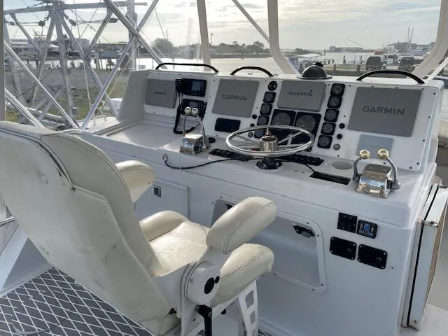 Slide: The Image of 1985 Bertram 38 Convertible helm with Garmin navigation systems and captain's chair. - 17