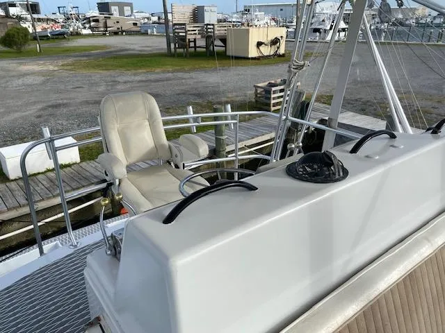 Slide: The Image of 1985 Bertram 38 Convertible boat helm with captain's chair and marina background. - 20
