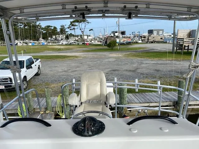 Slide: The Image of 1985 Bertram 38 Convertible boat helm with marina view. - 21