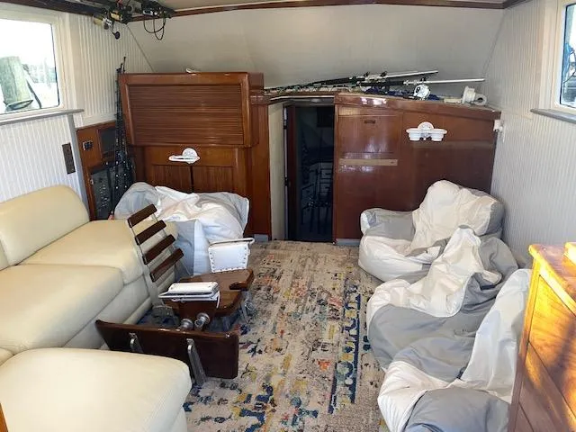 Slide: The Image of Interior of 1985 Bertram 38 Convertible yacht with cozy seating and fishing gear. - 25