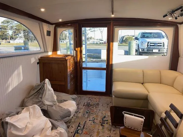 Slide: The Image of Interior of 1985 Bertram 38 Convertible yacht with beige sofa and wooden accents. - 27