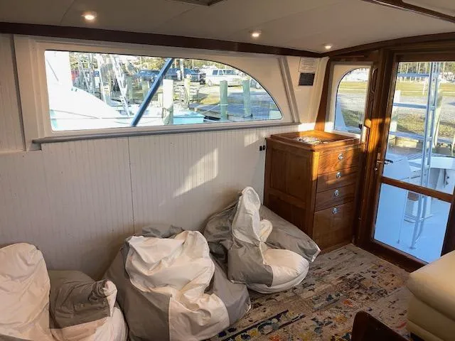 Slide: The Image of Interior of 1985 Bertram 38 Convertible yacht with bean bags and wooden cabinet. - 29