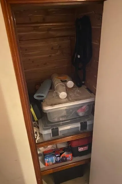 Slide: The Image of Storage closet on a 1985 Bertram 38 Convertible boat with various supplies. - 39