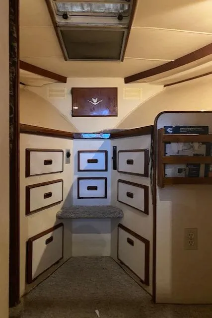Slide: The Image of Interior of 1985 Bertram 38 Convertible boat with storage drawers and wood accents. - 40
