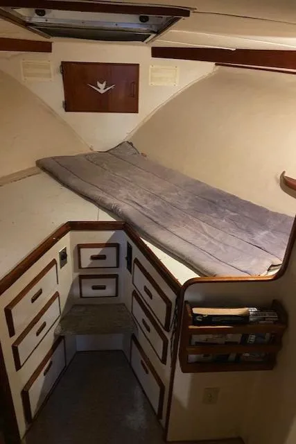 Slide: The Image of 1985 Bertram 38 Convertible cabin interior with bed and storage drawers. - 41