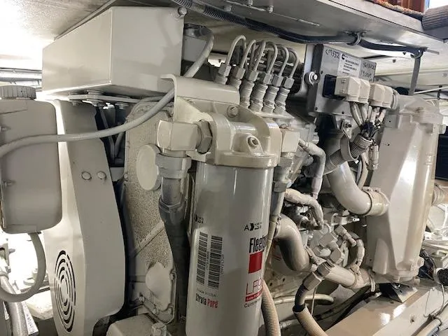 Slide: The Image of Engine room of 1985 Bertram 38 Convertible boat, showcasing mechanical components and wiring. - 44